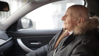 smiling senior man in modern car